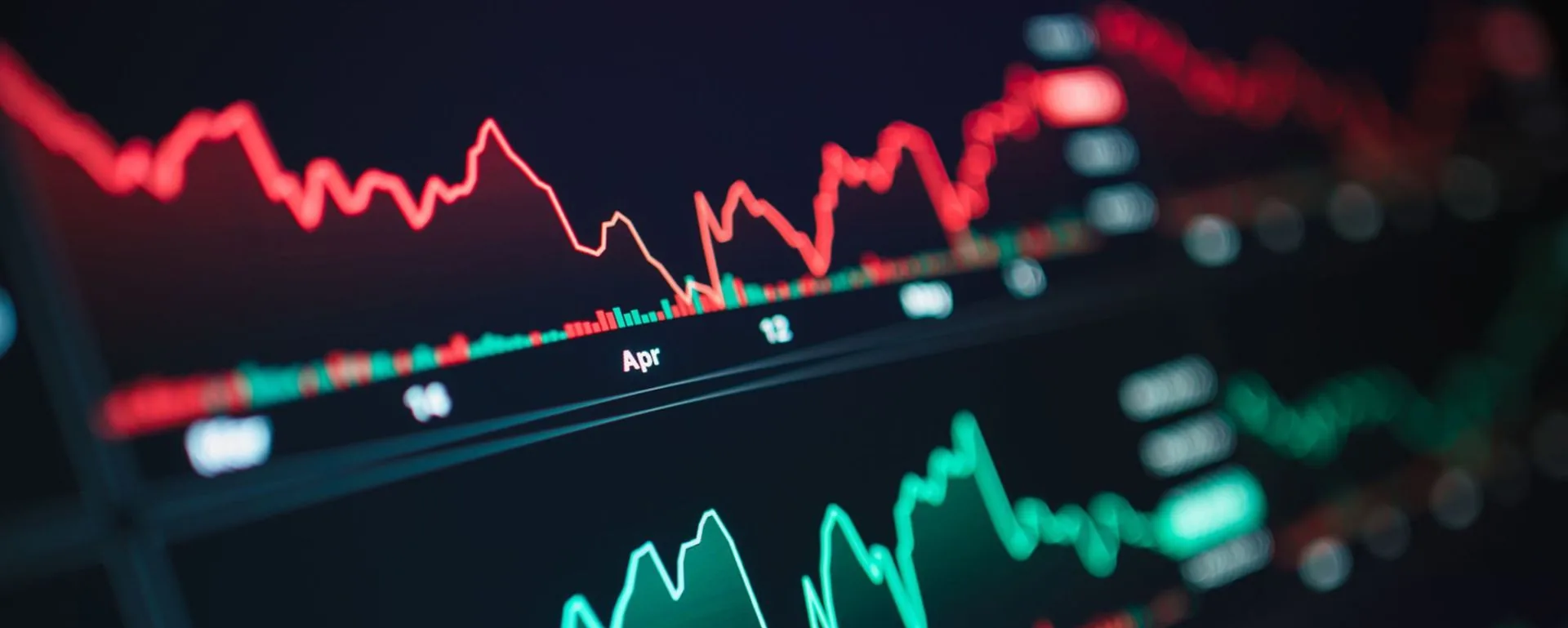Close-up of a screen showing volatile red and green financial trend lines