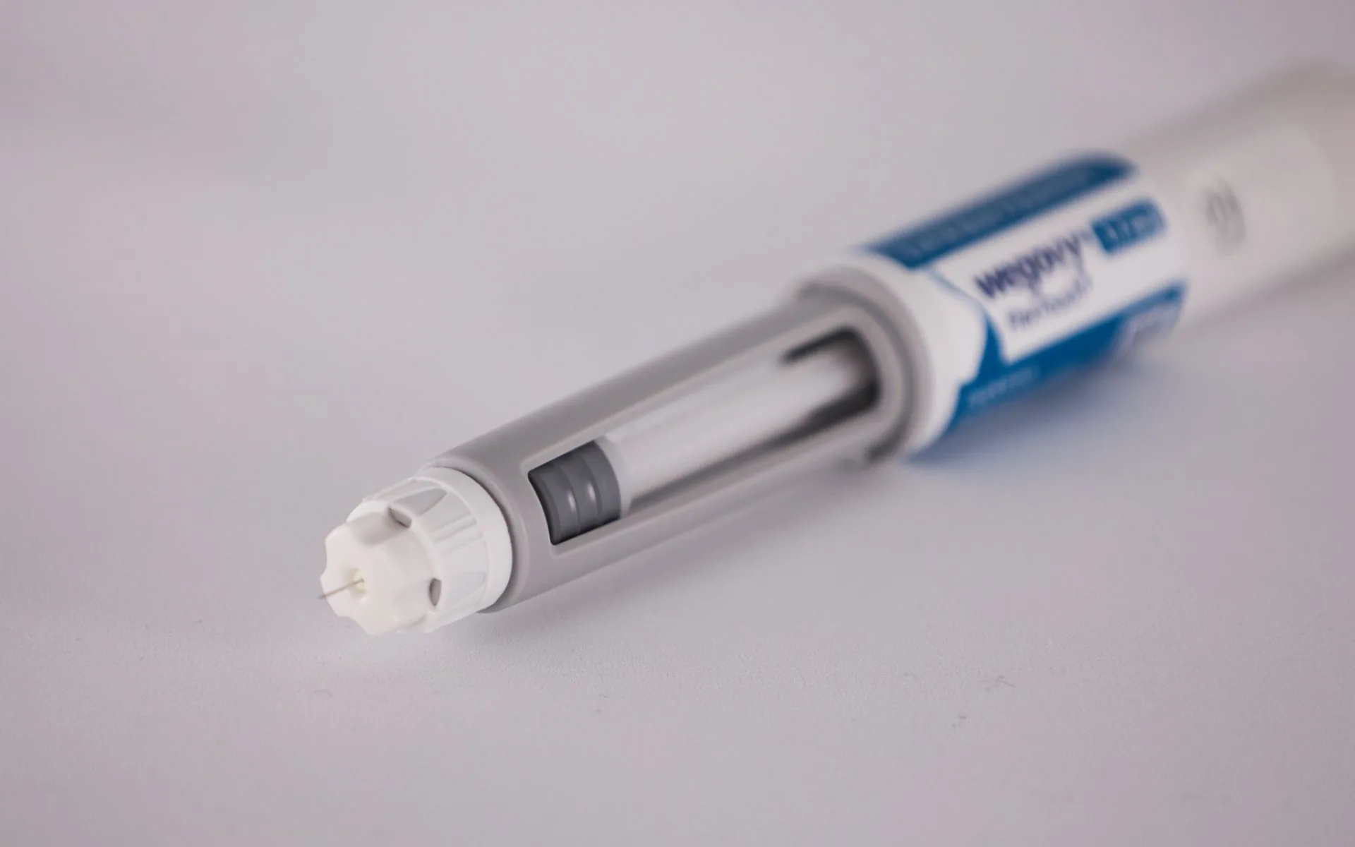 Wegovy injectable weight-loss pen lying on a plain white surface