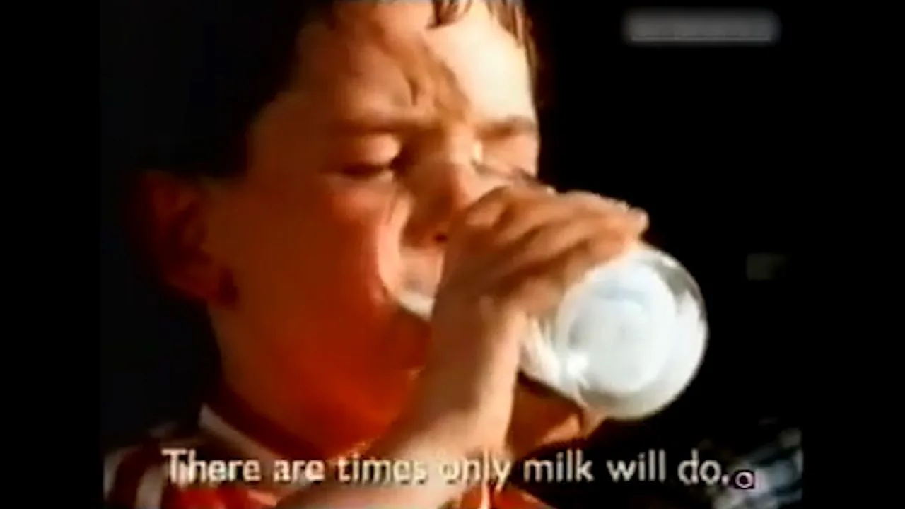 Retro advert still of a boy drinking milk captioned only milk will do